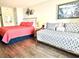 Comfortable bedroom features a coral bed, a daybed and neutral walls at 1207 S Ocean Blvd. # 51104, Myrtle Beach, SC 29577