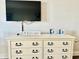 Bright, white dresser decorated with beach themed art and a sign that reads 'Live the life you imagined' at 1207 S Ocean Blvd. # 51104, Myrtle Beach, SC 29577