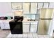 Well-organized kitchen featuring an electric stove, microwave, stainless refrigerator, and white cabinets at 1207 S Ocean Blvd. # 51104, Myrtle Beach, SC 29577