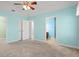 Aqua bedroom leading to bathroom and closet, carpeted floor, and a ceiling fan at 125 Dayglow Dr., Loris, SC 29569