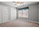Comfortable bedroom with plush carpeting, neutral walls, a ceiling fan, and a closet at 125 Dayglow Dr., Loris, SC 29569