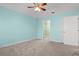 Aqua bedroom leading to walk-in closet, carpeted floor, and a ceiling fan at 125 Dayglow Dr., Loris, SC 29569