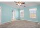 Aqua bedroom with ceiling fan, carpeted floor, and bright natural light at 125 Dayglow Dr., Loris, SC 29569