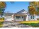 Charming single-story home with a well-manicured lawn, attached garage, and covered front porch at 125 Dayglow Dr., Loris, SC 29569