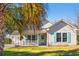 Inviting single-story home featuring a covered front porch and lush, green lawn at 125 Dayglow Dr., Loris, SC 29569