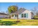 A cozy home featuring light siding, a welcoming porch, and vibrant teal shutters at 125 Dayglow Dr., Loris, SC 29569