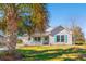 Inviting single-story home with light siding, a white picket porch, and teal shutters at 125 Dayglow Dr., Loris, SC 29569