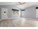 Bright living room with vaulted ceilings, wood-look floors, and large windows at 125 Dayglow Dr., Loris, SC 29569