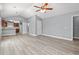Light-filled living space featuring hardwood floors and an open floorplan leading to the kitchen at 125 Dayglow Dr., Loris, SC 29569