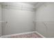 Walk-in closet offering carpeted floor and white shelving for storage at 125 Dayglow Dr., Loris, SC 29569