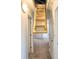Hallway showing access to attic with pull-down stairs and hallway with carpeted floors at 1330 Reflection Pond Dr., Little River, SC 29566