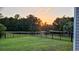 Expansive backyard with lush greenery, a tranquil pond, and a sturdy fence, offering a peaceful and private outdoor retreat at 1330 Reflection Pond Dr., Little River, SC 29566