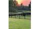 Beautiful backyard showcasing a pond view, secure fencing, and vibrant greenery at 1330 Reflection Pond Dr., Little River, SC 29566