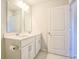 Bathroom featuring double sink vanity, marble countertop, tiled floors, and a white door at 1330 Reflection Pond Dr., Little River, SC 29566