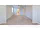 A large bedroom with neutral walls, neutral carpet, a ceiling fan, and two doorways to the hallway at 1330 Reflection Pond Dr., Little River, SC 29566