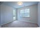 Neutral bedroom with carpet, a window for natural light, and a door that leads to the fenced-in backyard at 1330 Reflection Pond Dr., Little River, SC 29566