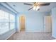 Cozy bedroom featuring a ceiling fan, large window, and a walk-in closet at 1330 Reflection Pond Dr., Little River, SC 29566