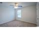 Bright carpeted bedroom with a ceiling fan and a window providing natural light at 1330 Reflection Pond Dr., Little River, SC 29566