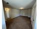 Open bonus room features brown carpet, neutral paint, and ample space to spread out at 1330 Reflection Pond Dr., Little River, SC 29566