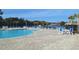 Community pool surrounded by lots of chairs and tables with a green perimeter of trees at 1330 Reflection Pond Dr., Little River, SC 29566
