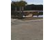 A wooden dock extends into a tranquil lake, with palm trees and lush greenery surrounding the area at 1330 Reflection Pond Dr., Little River, SC 29566