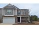 Attractive two-story home with stone accents, a front-facing garage, and well-kept landscaping at 1330 Reflection Pond Dr., Little River, SC 29566