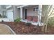 Charming home exterior with landscaped flower beds and two red chairs on the front porch at 1330 Reflection Pond Dr., Little River, SC 29566