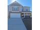Charming two-story home with neutral siding, stone accents, covered porch, and an attached two-car garage at 1330 Reflection Pond Dr., Little River, SC 29566
