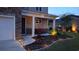 Inviting home exterior with lush landscaping, landscape lighting, and a covered front porch, perfect for enjoying the outdoors at 1330 Reflection Pond Dr., Little River, SC 29566