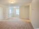 Open hallway area with neutral carpet, natural light, and access to multiple rooms at 1330 Reflection Pond Dr., Little River, SC 29566