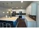 Bright kitchen featuring white cabinets, stainless steel appliances, an island with barstool seating, and pendant lighting at 1330 Reflection Pond Dr., Little River, SC 29566
