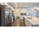 Modern kitchen with stainless steel appliances, white cabinets, a center island with sink, and hardwood floors at 1330 Reflection Pond Dr., Little River, SC 29566