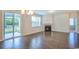 Bright living room with hardwood floors, a fireplace, and sliding glass doors that lead to a screened porch at 1330 Reflection Pond Dr., Little River, SC 29566