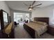 Spacious bedroom suite with a large bed, stylish decor, a ceiling fan, and a seating area at 1330 Reflection Pond Dr., Little River, SC 29566