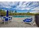 Community pool featuring lounge chairs, blue umbrellas, and seating, surrounded by lush landscaping at 1330 Reflection Pond Dr., Little River, SC 29566