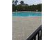 A community pool features clear, blue water, brick trim and views of surrounding trees at 1330 Reflection Pond Dr., Little River, SC 29566