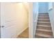 View of the carpeted stairs with white railing, and closet under the stairs at 1330 Reflection Pond Dr., Little River, SC 29566