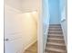 A carpeted stairwell next to the doorway features neutral walls, trim and a view to an upstairs window at 1330 Reflection Pond Dr., Little River, SC 29566
