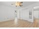 Bedroom featuring light wood laminate flooring, a ceiling fan, and connecting doors to a bathroom at 1440 Blue Tree Ct. # N, Myrtle Beach, SC 29588