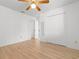 Bedroom with laminate floors, ceiling fan, closet, and doorway leading to the adjacent bathroom and bedrooms at 1440 Blue Tree Ct. # N, Myrtle Beach, SC 29588