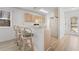 Cozy kitchen featuring a breakfast bar with seating, light wood cabinetry, and white appliances at 1440 Blue Tree Ct. # N, Myrtle Beach, SC 29588