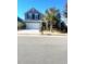 Charming two-story home with a two-car garage, mature landscaping, and a well-maintained lawn at 1575 Berkshire Ave., Myrtle Beach, SC 29577