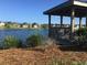 Scenic lake view featuring a wooden gazebo with neighborhood houses in the background at 1575 Berkshire Ave., Myrtle Beach, SC 29577