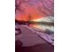 Serene lake view with a paved walking path, snow covered banks, and colorful sunset at 1575 Berkshire Ave., Myrtle Beach, SC 29577