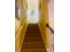 Carpeted staircase with white railing and yellow walls leads to the upper level of the home at 1575 Berkshire Ave., Myrtle Beach, SC 29577