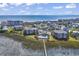 Beautiful aerial view of oceanfront property with a pool, wooden walkway to the beach, and lovely landscaping at 1582 S Waccamaw Dr. # 44, Murrells Inlet, SC 29576
