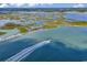 Scenic aerial view of waterfront location with a speed boat leaving a wake, lush greenery and a calm lake at 1582 S Waccamaw Dr. # 44, Murrells Inlet, SC 29576
