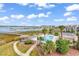 Aerial view showcasing the pool, gazebo, pier, and scenic waterfront of the property at 1582 S Waccamaw Dr. # 44, Murrells Inlet, SC 29576