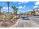 Gated Inlet Pointe Condominiums entrance with lush landscaping and palm trees giving a resort-style feel at 1582 S Waccamaw Dr. # 44, Murrells Inlet, SC 29576