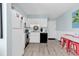 Bright white kitchen with light wood flooring, white appliances and adjacent breakfast table at 1582 S Waccamaw Dr. # 44, Murrells Inlet, SC 29576